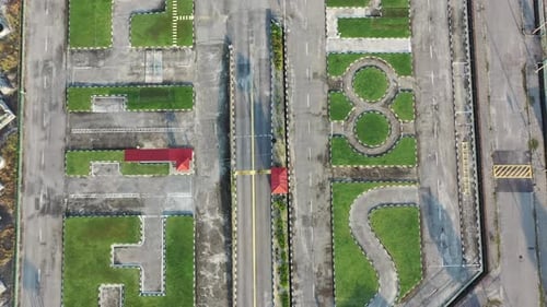 Vertical top down aerial view, drone flyover driving training course at perak malaysia with palm tre