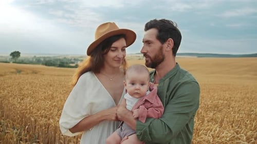 Happy Family Posing in a Golden Wheat Field