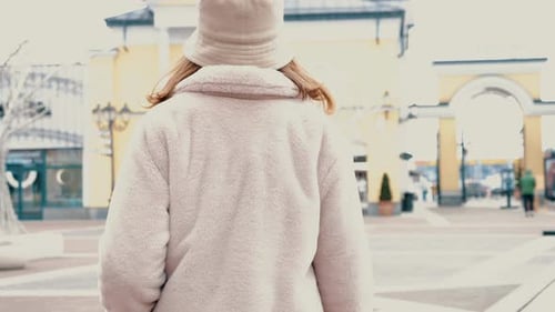Stylish Woman Walking Through Outdoor Shopping Center