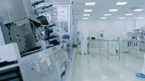 In the Laboratory Scientist Wearing Sterile Protective Coverall Set's up / Programs Modern Industri