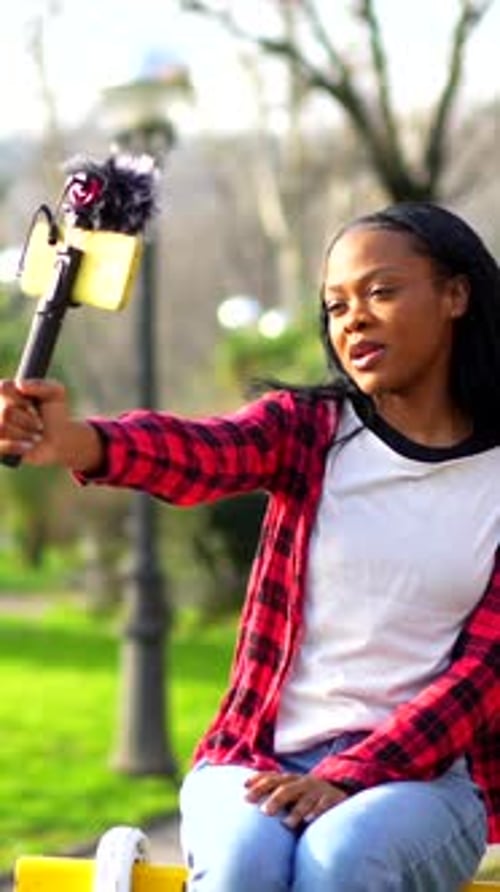 Young African Vlogger Records a Video in a Park