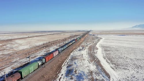 the railway and the view of a moving train and the roofs of freight cars
