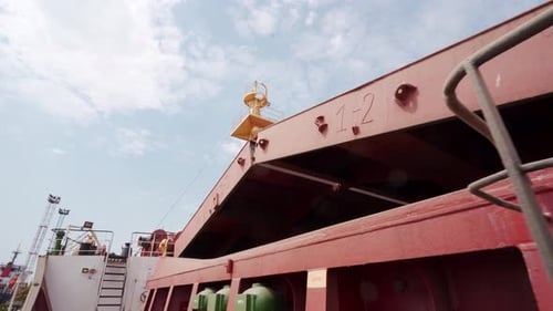Seafarer Opening Cargo Holds on Bulker Ship at Grain Terminal in Sea Port for Loading Crops