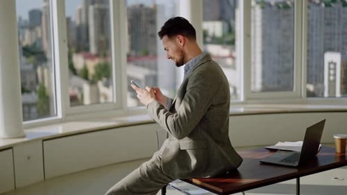 Man Using Mobile Phone in City Office