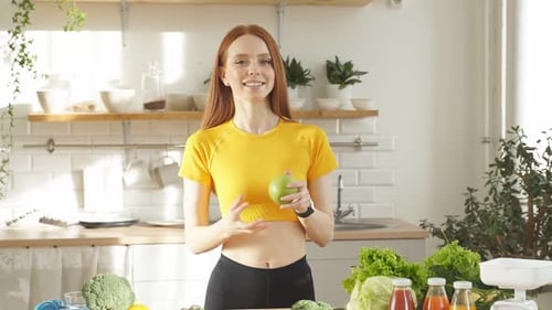 A Happy Woman Stands at a Table with a Lot of Fruits and Vegetables She Eats Right and Takes Care of