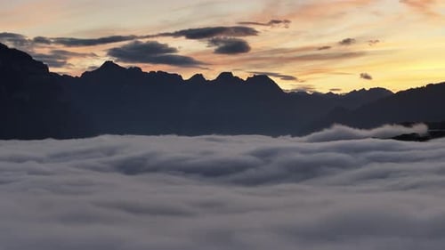 Aerial view of Lake Walensee in Switzerland, blanketed in a thick layer of fog and clouds.