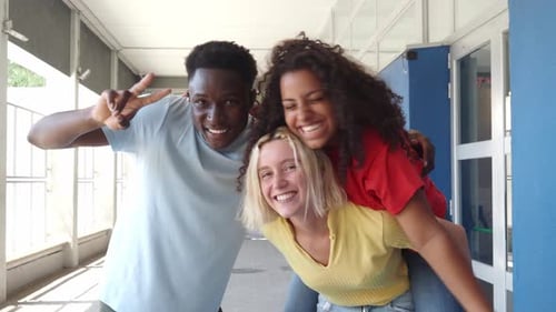 Cheerful Friends Posing in School Hallway