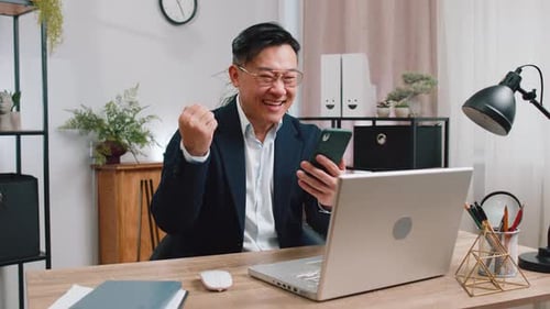 Enthusiastic Man Celebrating Success While Video Conferencing