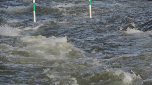 Green downstream white water kayak and canoe slalom gate. In slowmotion.