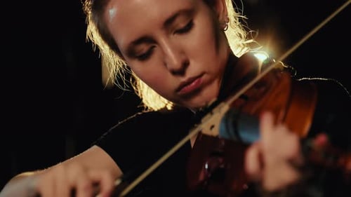 Beautiful Lady Musician Playing Violin in Rain in Night Dark and Light Close Up Expressing Romantic