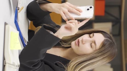 Vertical video of Businesswoman using smart mobile phone.