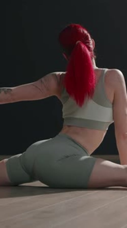 Vertical Back View of Red Haired Woman Sitting in Split on Floor