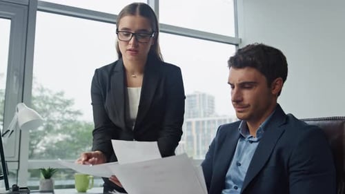 Upset Workers Check Documents in Office