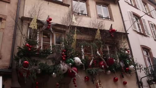 christmas bells and tinsel decorating storefronts on european street at a Festive Christmas market i