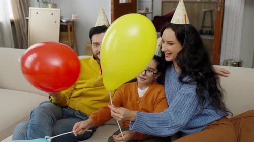 Family Celebrates Birthday with Balloons at Home