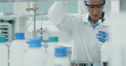 Woman Scientist Works in Bright Laboratory