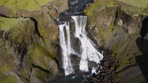 Aerial view of fagrifoss waterfall in scenic valley, Iceland.