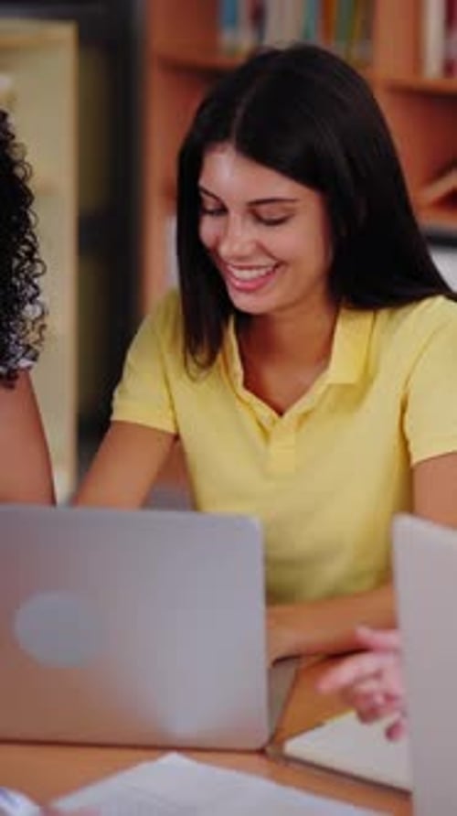 Group Young High School Students Meeting Doing Classwork Together Using Laptop Sitting in Library