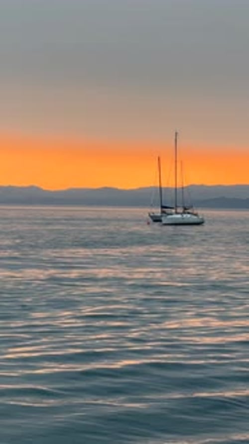 A Yacht Sails in the Sea During a Beautiful Sunset