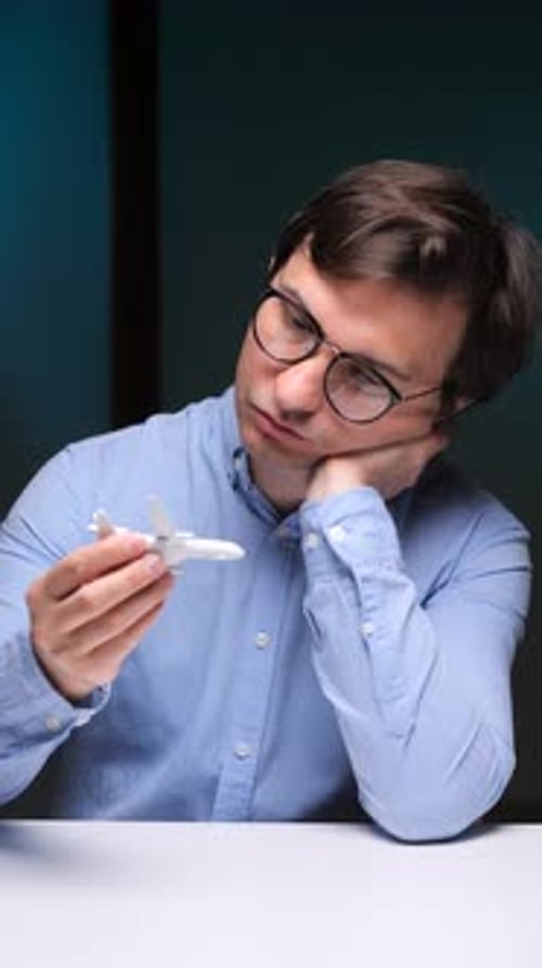 Man with Toy Airplane Dreaming of Travel