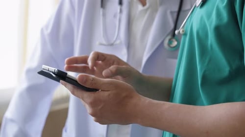 Close up hands of doctors using digital tablet to check patient treatment information
