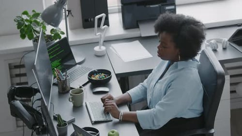 African American Woman Program Coding on Computer in Office