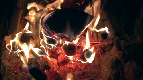 Crackling Fireplace Embers Glowing with Orange Warmth