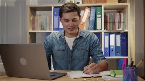 Handsome Smart Office Employee Managing Business Doing Paperwork and Using Notebook Computer While