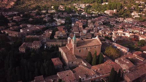 Aerial shot of Valldemossa curch and cityscape, Mallorca, Spain, surrounded by mountains