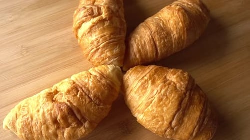 Golden Brown Croissants Arranged on Wood Surface