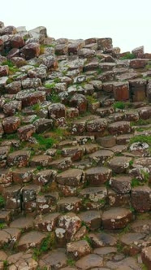Tight reversing social ratio aerial video of The Giant's Causeway in Bushmills, Northern Ireland