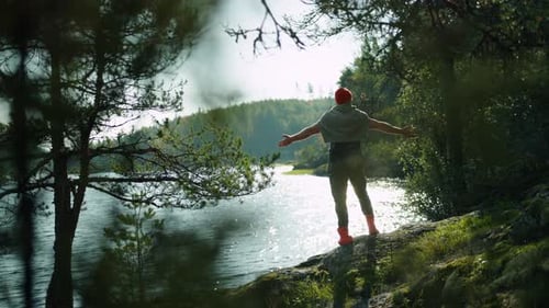 Man Travelers Enjoying Beauty Of Nature On Shore Of Lake Putting Hands Up Back View