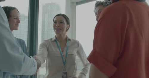 Cheerful Business People Shaking Hands in Modern Office