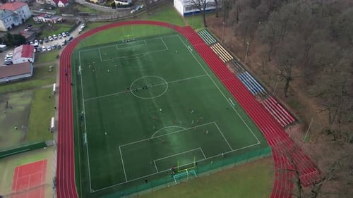 Aerial View of Stadium in Small Town Players Play Football on Soccer Field