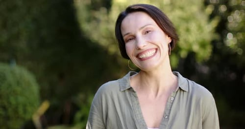 Smiling Woman Posing in an Outdoor Setting