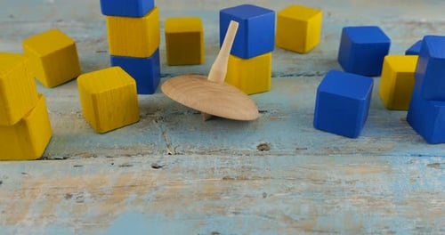 Peg toy or whirligig rotates on a vintage wooden board