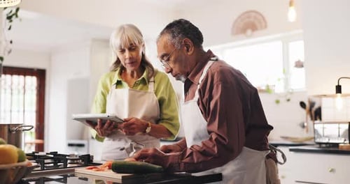 Senior Couple Preparing Food in Bright Kitchen