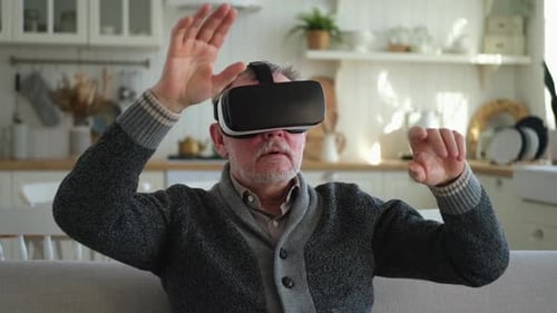 Senior Man Using Virtual Reality Headset at Home