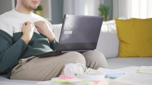 Young Adult Working from Home on Laptop