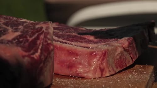 Raw Steak Placed on Wooden Cutting Board