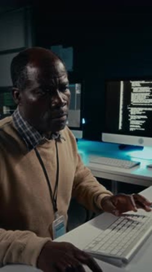 Programmer Working Late at Night on Keyboard