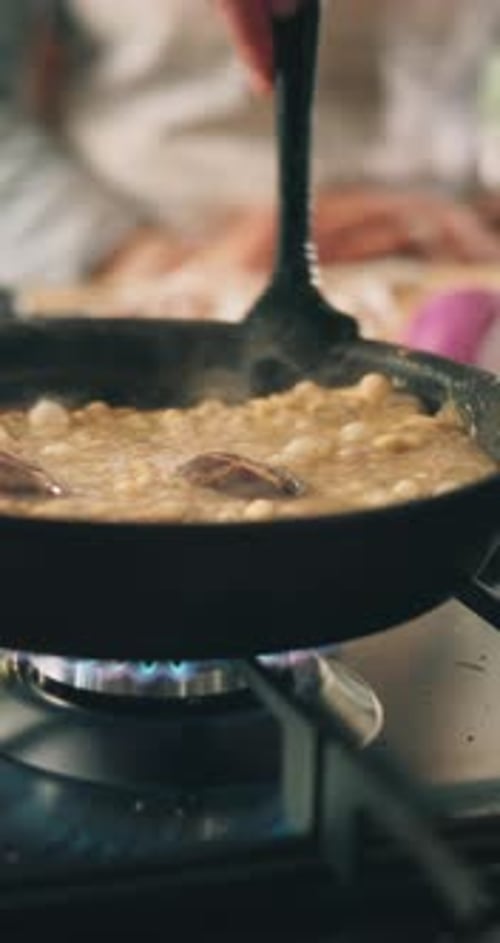 Food frying in the pan on the stove
