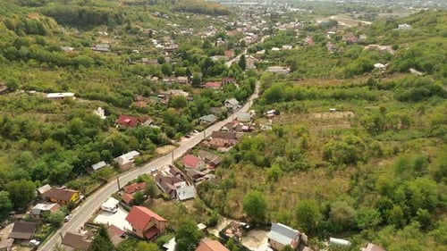Smooth Aerial View Above a Small and Quiet Village in a Forest Near the City 60fps