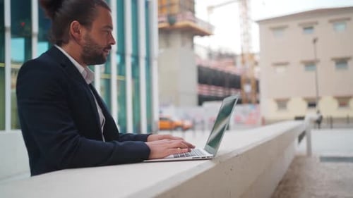 Businessman Standing Outside with Laptop Working Remote Distant Job Outdoors Near Office