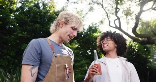 Two Young Men Chatting in a Backyard