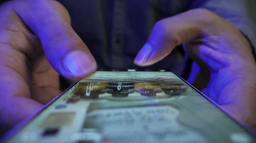 Hands Scroll Social Media on a Smart Phone