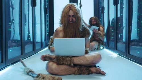Caveman Using Laptop Computer in Data Center