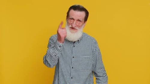 Senior Man with White Beard Points Towards Camera