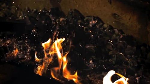 The Coals are Stirred in the Oven with a Fireball with Flames