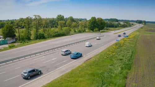 Cars driving on a highway. Electronic blue automobile moving slowly on the road.